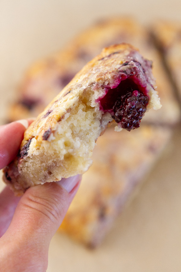 a scone with a bite tasken out of it so you can see the texture inside.