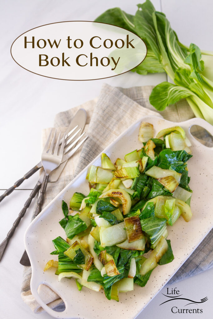 cooked bok choy on a serving platter with forks, knife, and fresh bok choy around it, title on image: How to Cook Bok Choy.