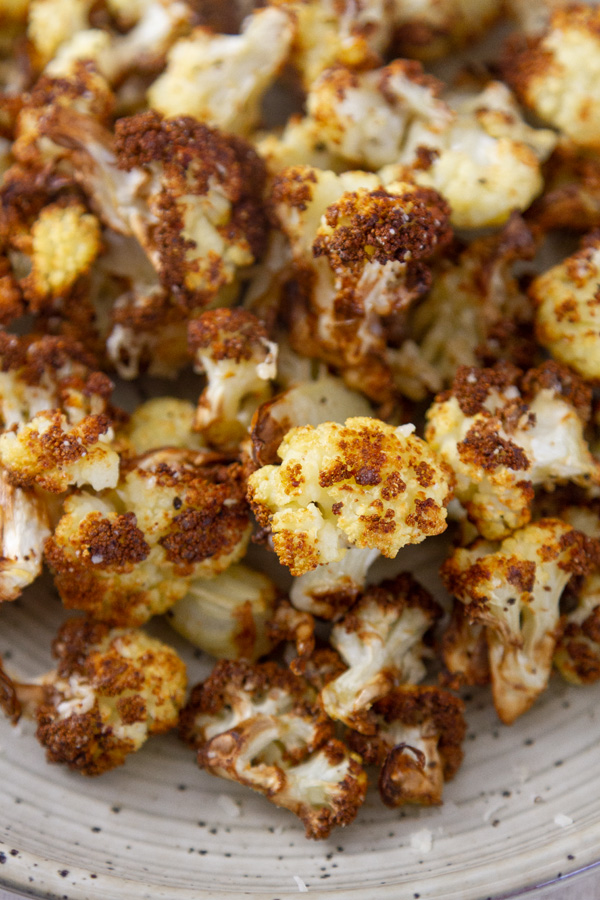looking down into a bowl filled with roasted cauliflower