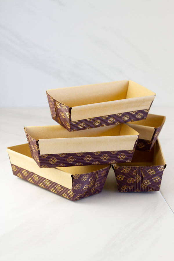 empty paper cake pans stacked on top of each other.