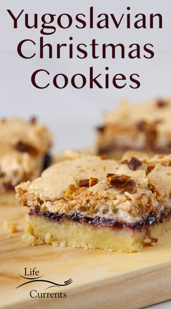 Yugoslavian Christmas Cookies on a wooden cutting board so you can see the layers inside the bar cookies.