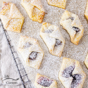 square crop of jam filled cream cheese cookies cooling on a wire rack.