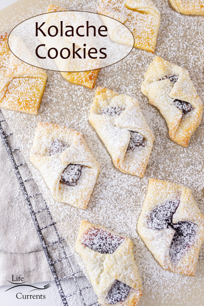 Kolache Cookies on a wire rack covered with powdered sugar.