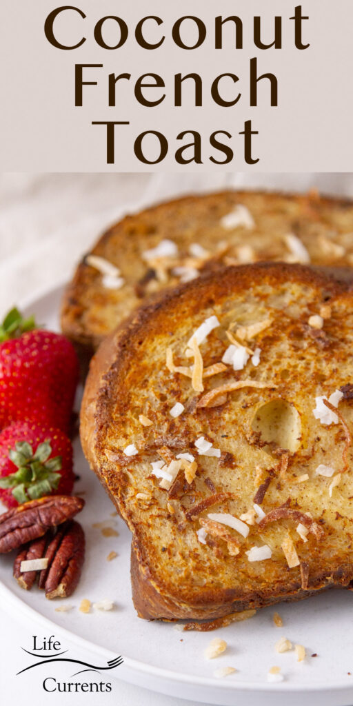 close up on two slices of coconut French Toast with strawberries and pecans next to them.