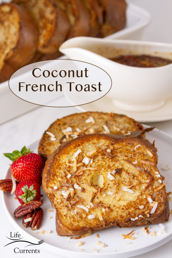 two slices of French toast with coconut, strawberries, and pecans, syrup in the background and a pan of french toast.