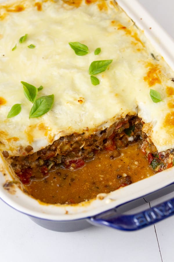 a large pan of lasagna with a big slice taken out.