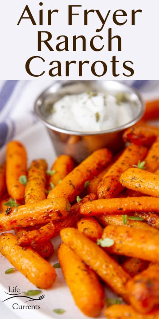 close up on cooked carrots with a side of ranch dressing, title on top: Air Fryer Ranch Carrots.