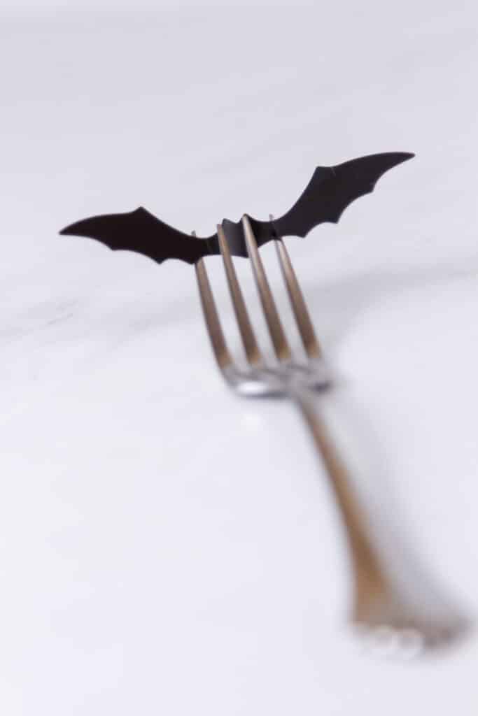 a fork with a paper bat on the end.