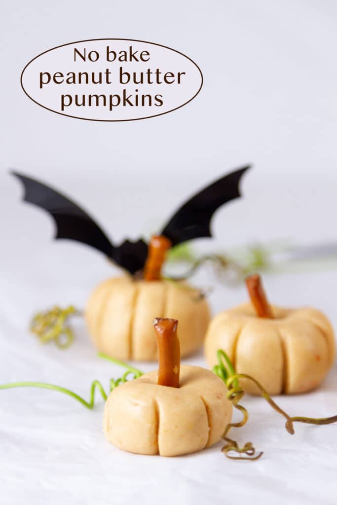 three peanut butter pumpkins with a bat in the background, title on upper left.