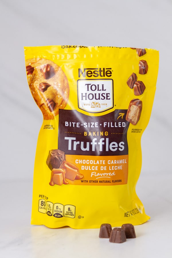 a bag of NESTL&Eacute;&reg; TOLL HOUSE&reg; Dulce de Leche Truffles with three truffles in front of the bag.