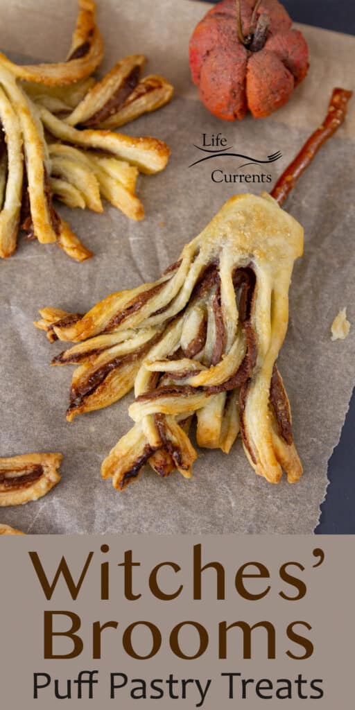 Looking down on Witches Brooms made from puff pastry on parchment paper with a pumpkin in the background.