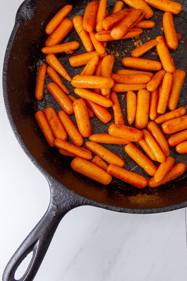 looking down into a skillet with carrots in it.