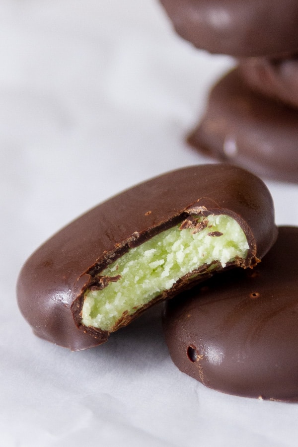 close up on a bitten piece of candy so you can see the texture inside the chocolate coating.