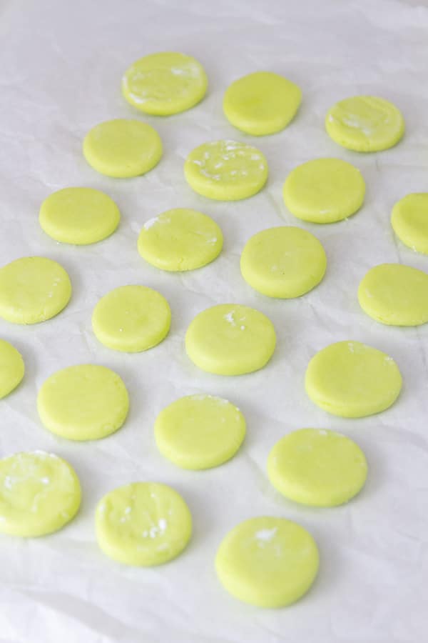 A bunch of peppermint candies on a piece of parchment paper.