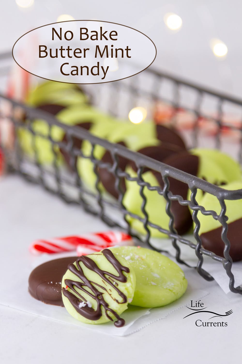 No Bake Butter Mint Candy in a wire tray with three candies in front, twinkle lights in the background.