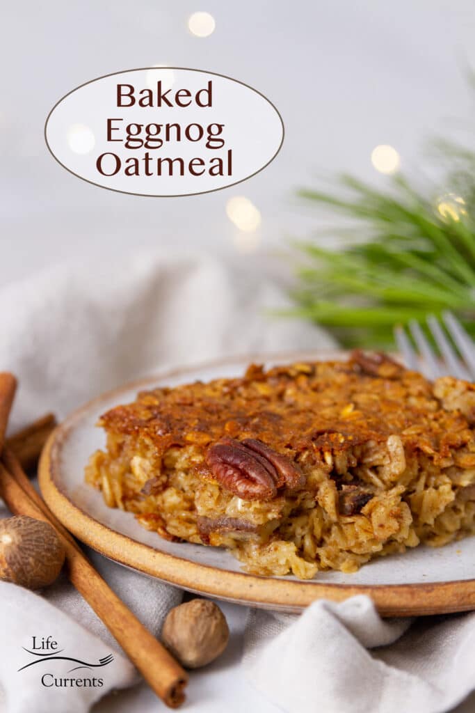 a slice of baked eggnog oatmeal on a plate with spices and pine boughs around.