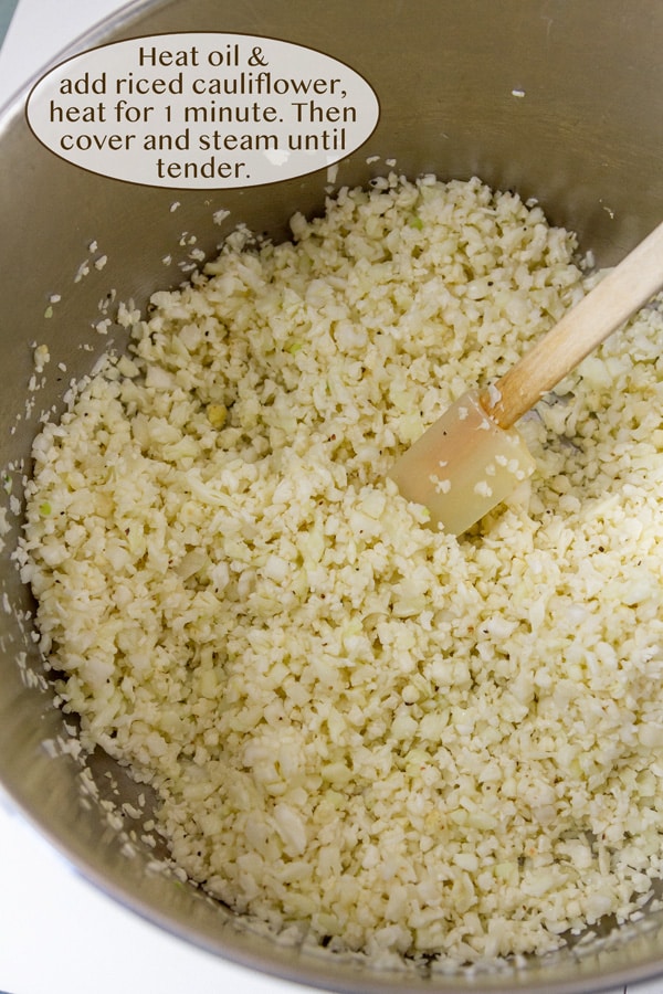 Looking down into a pot of cauliflower rice with a spatula in it.