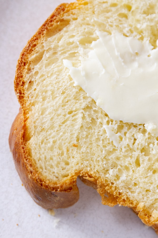 looking down on a slice of bread with butter smeared on it.