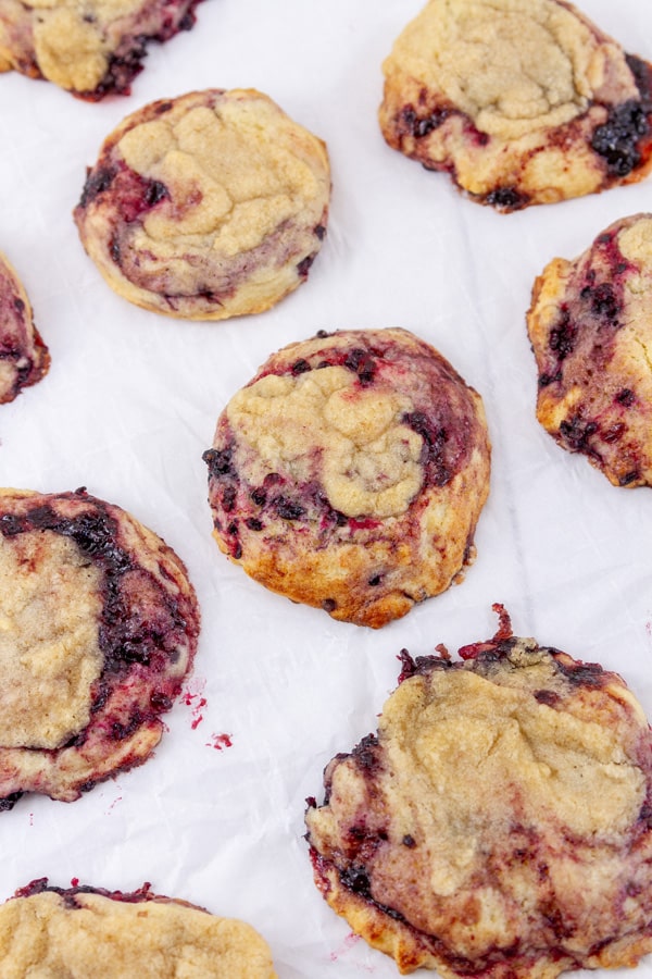 freshly baked blackberry cookies on white parchment paper.