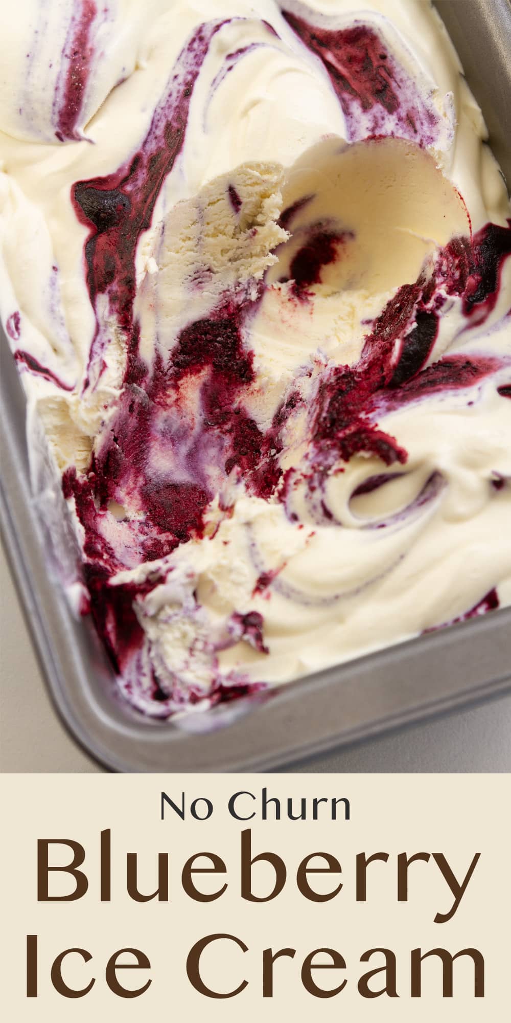 a metal pan filled with blueberry ice cream that's been scooped out.