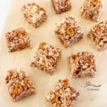 square crop of several rice crispy squares on a brown piece of parchment paper.