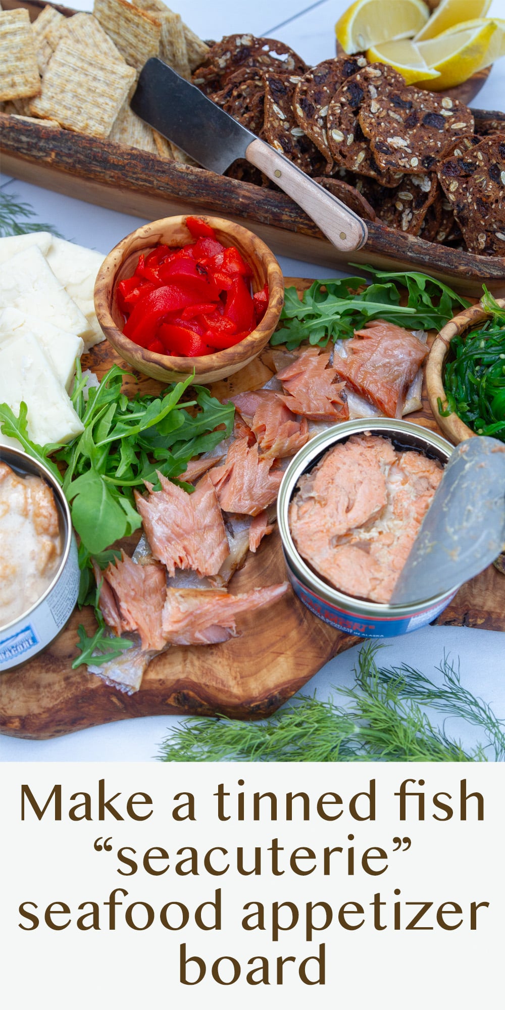 a seacuterie board on an olive wood board with crackers.