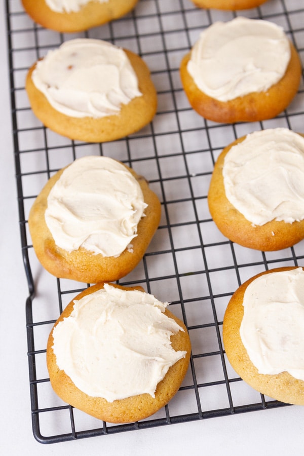 frosted cookies on a wire rack.