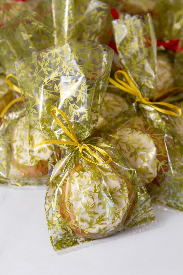 cookies in plastic bags ties with ribbons ready for a bake sale.