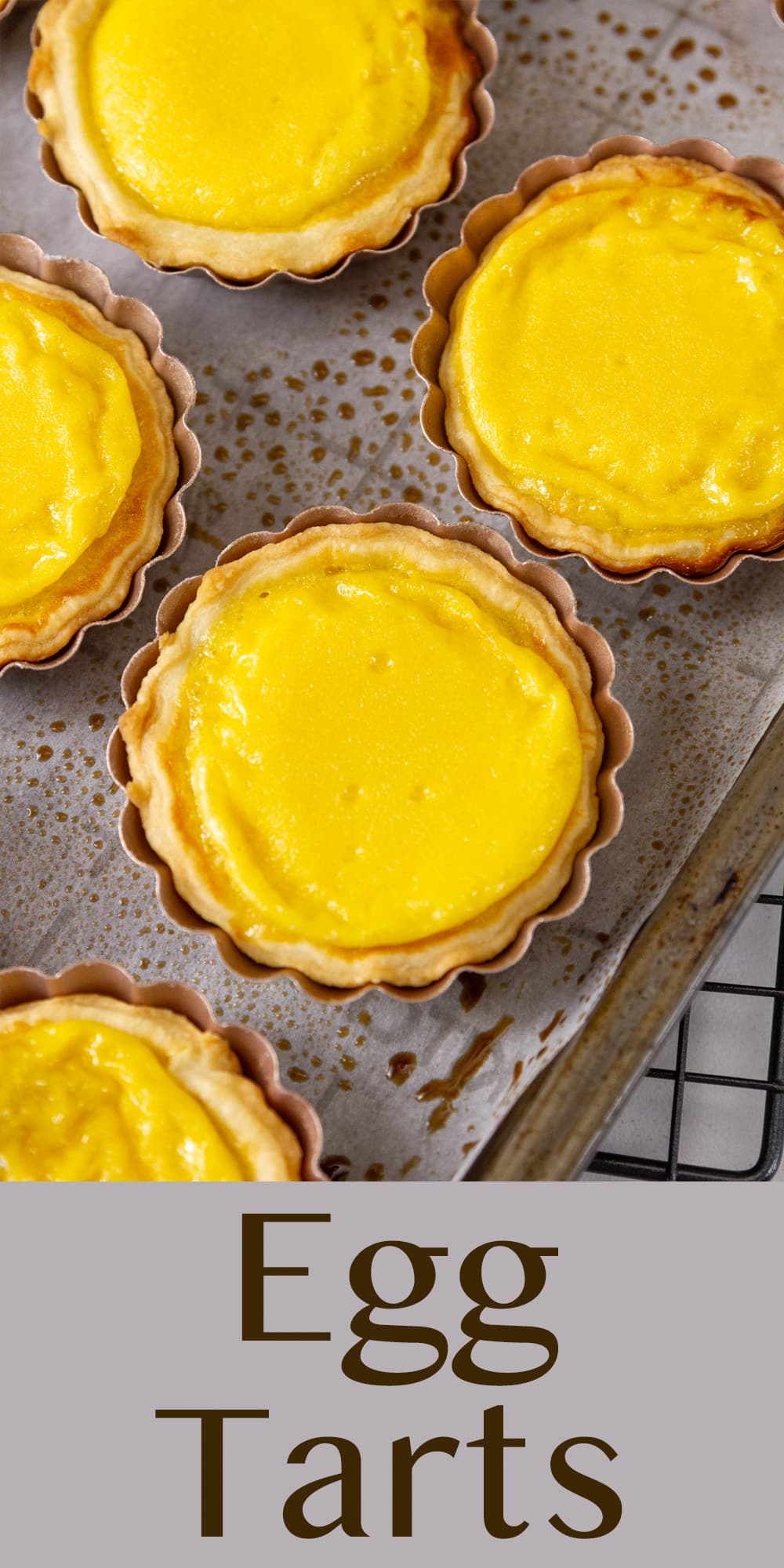 looking down on bright yellow tarts on a baking sheet.
