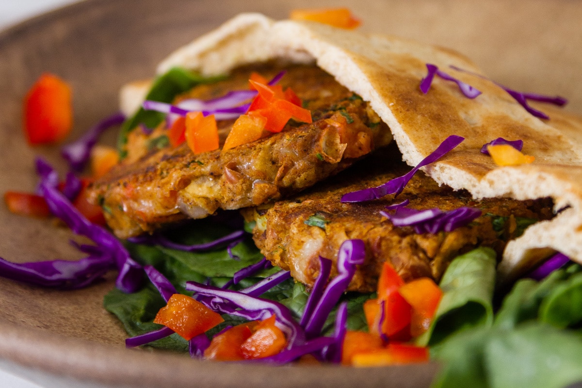 Southwestern Falafel in a pita bread with veggies on a brown plate.