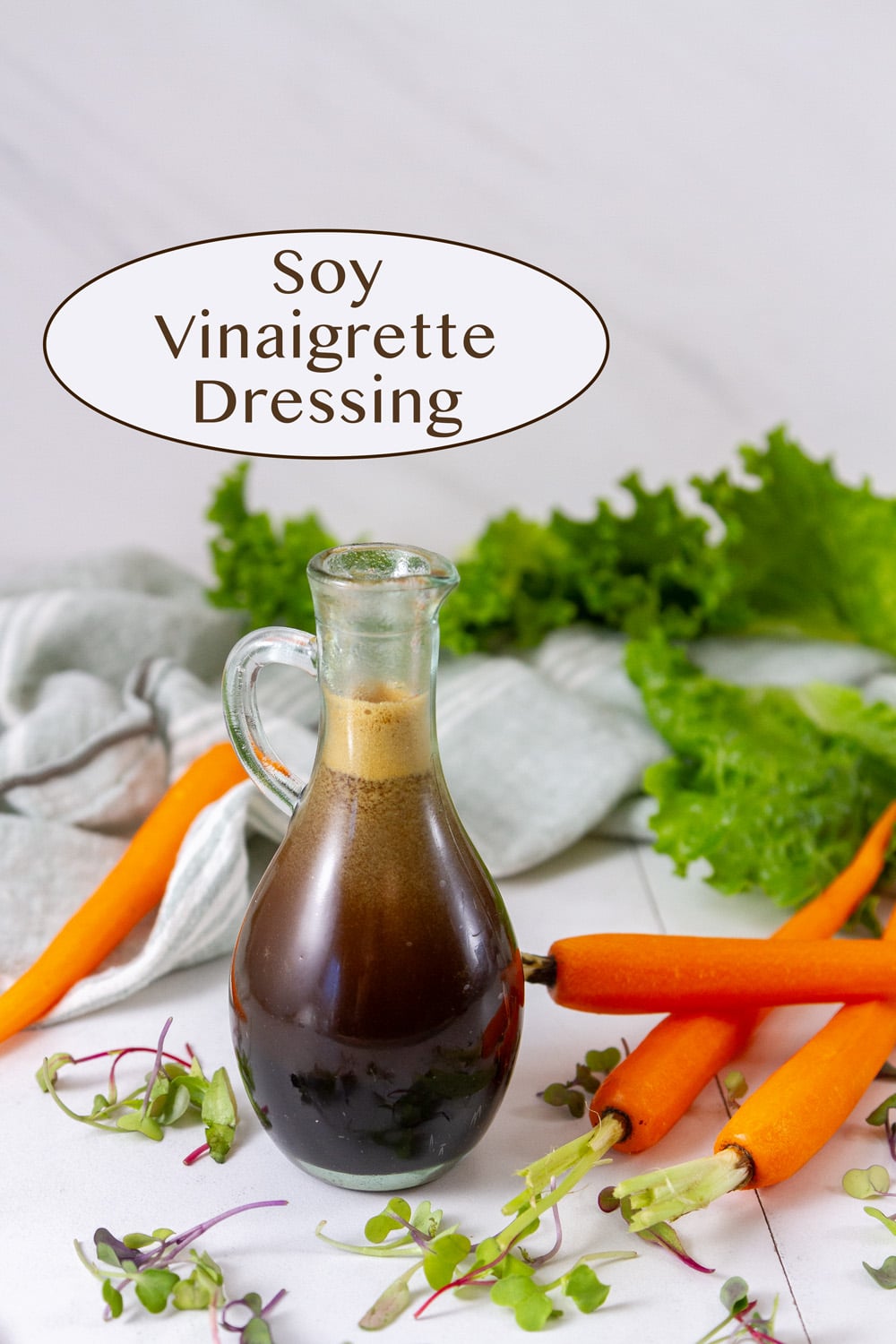 a bottle of salad dressing in front of salad ingredients and a cloth napkin.