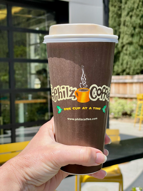 a Philz coffee drink being help by my hand.