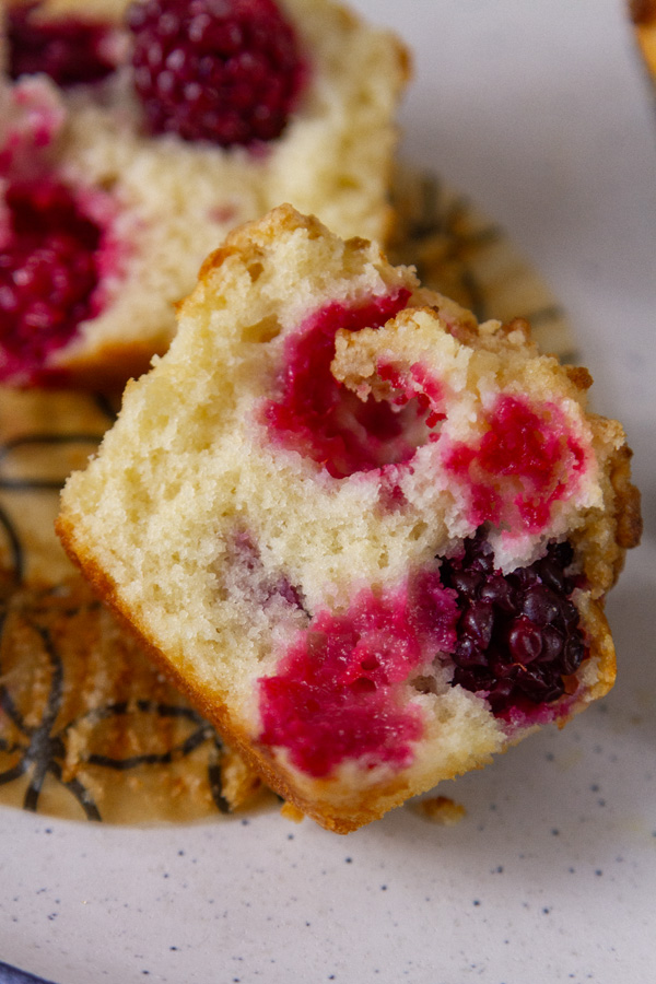 a blackberry muffin that's been cup open so you can see the inside.