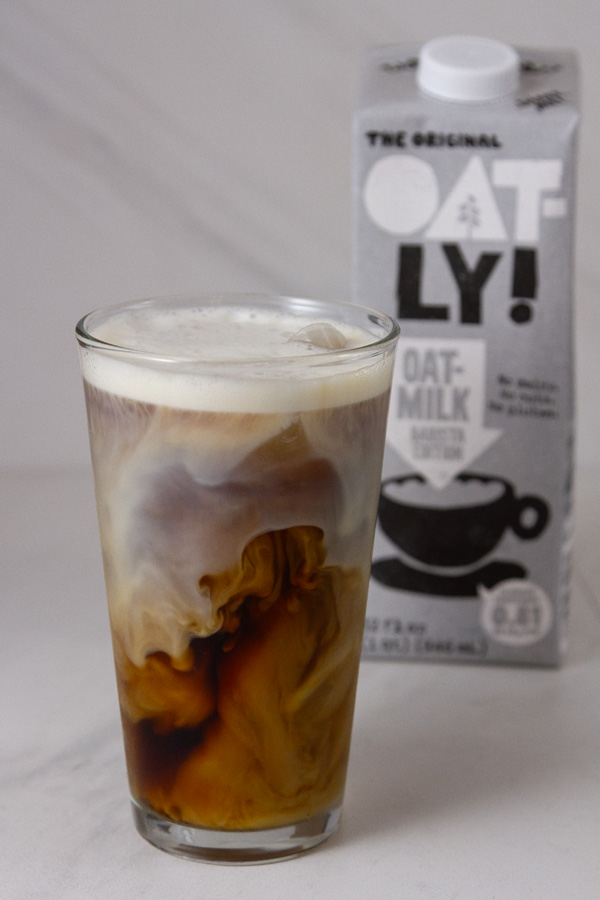 an iced coffee with oatmilk in the background.