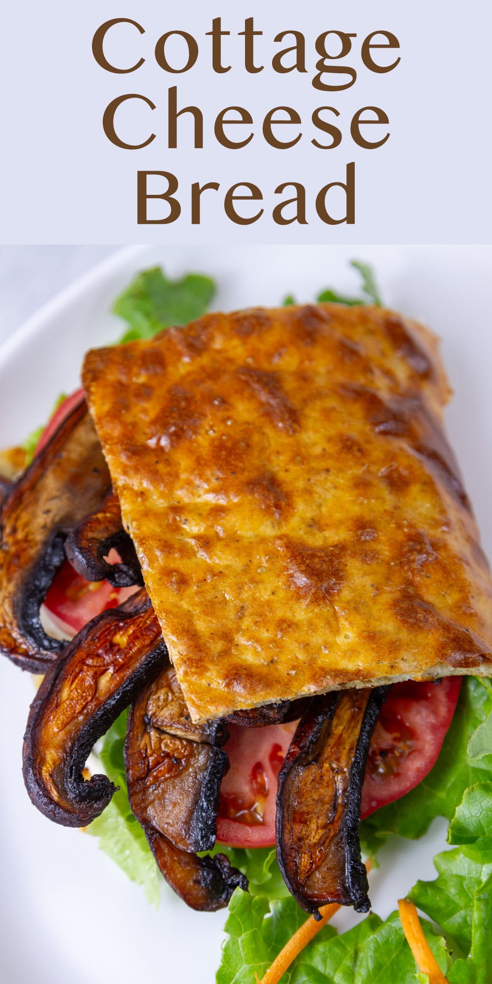flatbread around sandwich fillings of mushrooms, tomato, lettuce on a white plate.