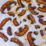 pieces of cooked mushrooms on a white parchment paper.