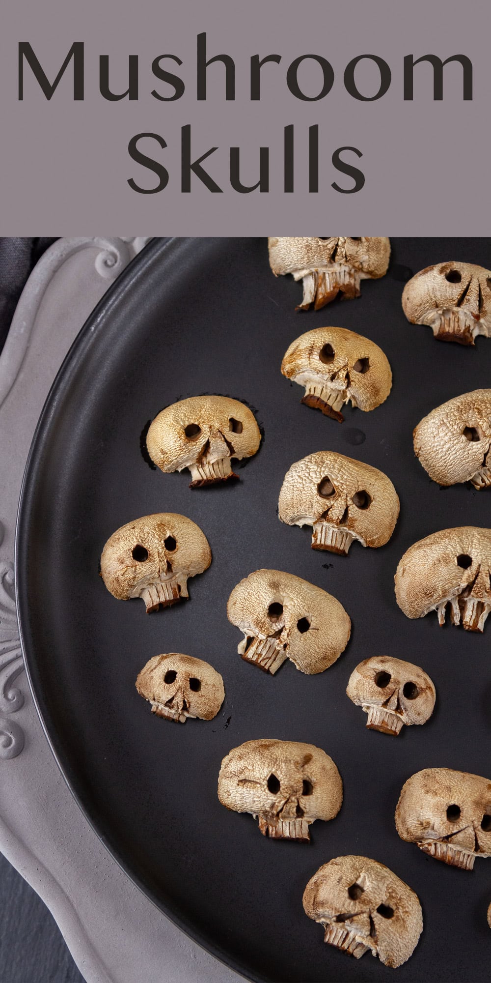 mushroom skulls on a black plate on a concrete charger.