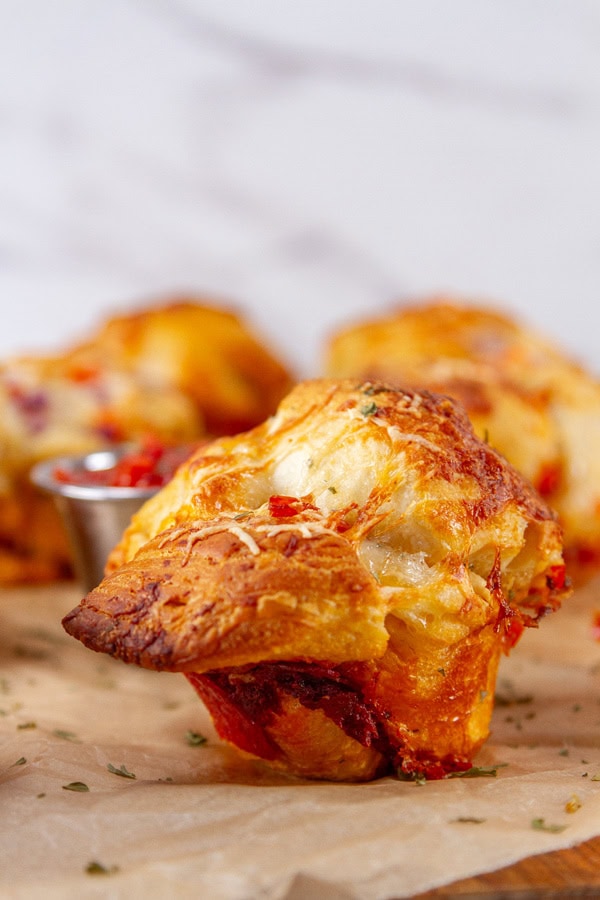 a muffin on a wooden cutting board.