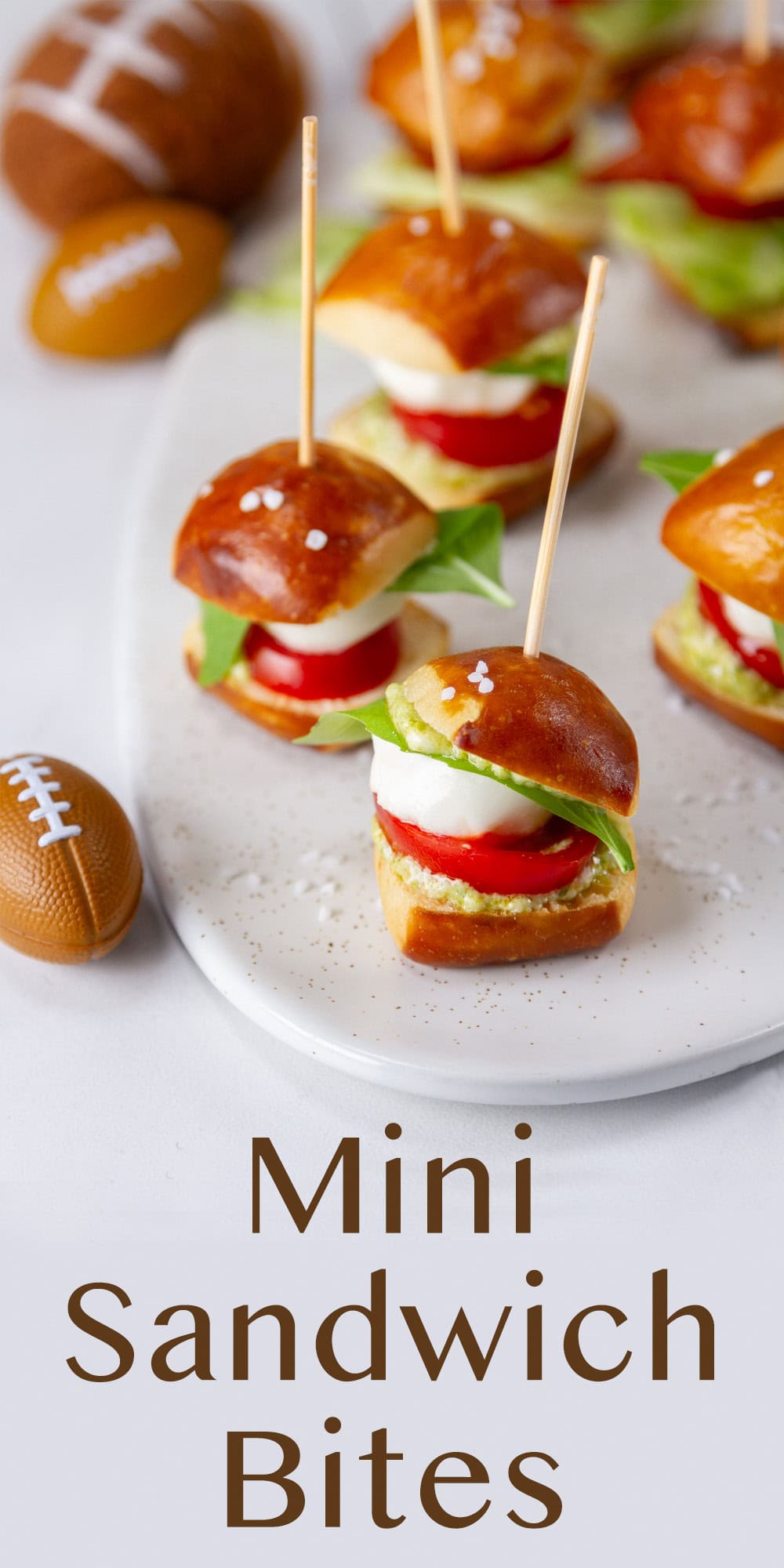caprese sandwiches in pretzel bites on a white plate.