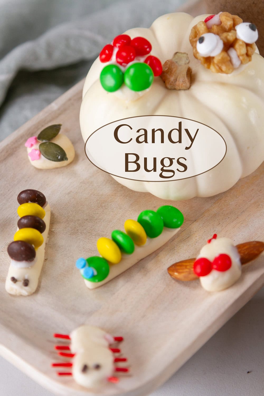 candy bugs on a wooden tray.