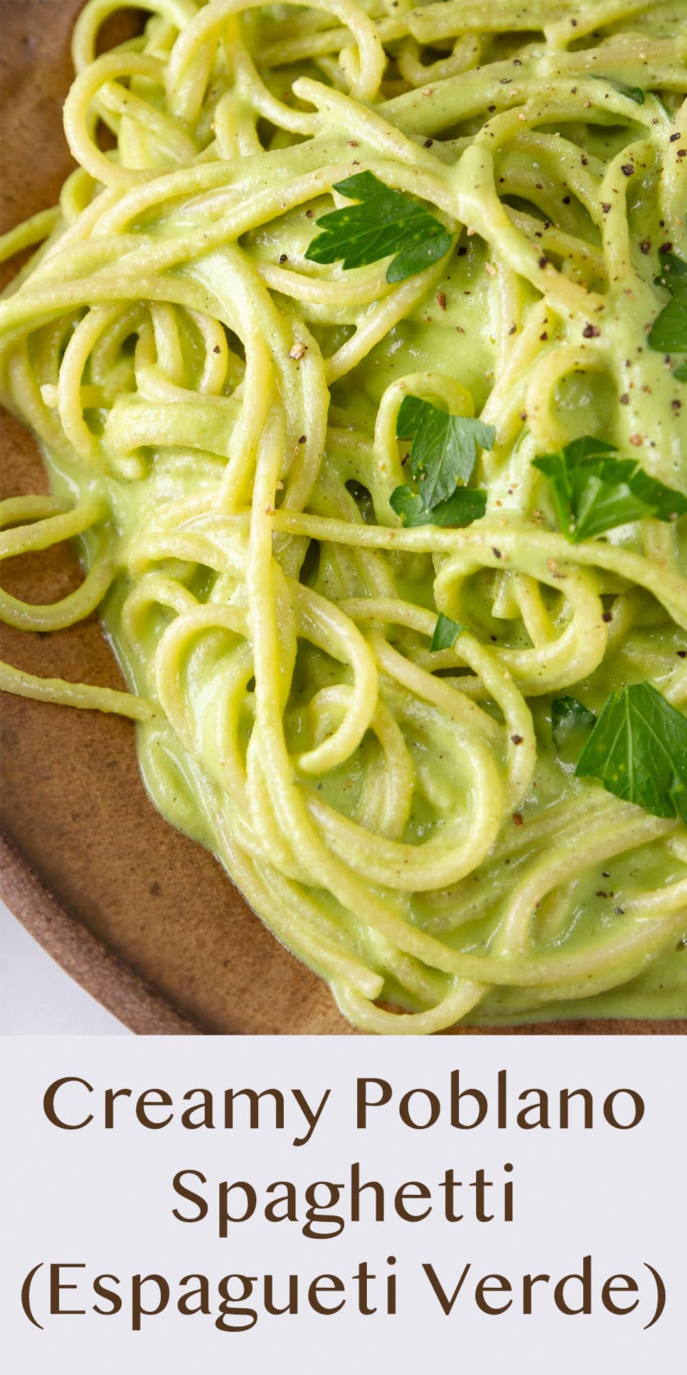 pasta in a creamy green sauce called Espagueti Verde in a brown bowl.