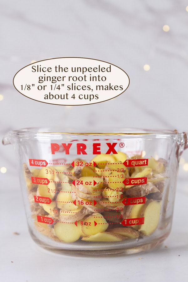 sliced ginger root in a glass measuring cup