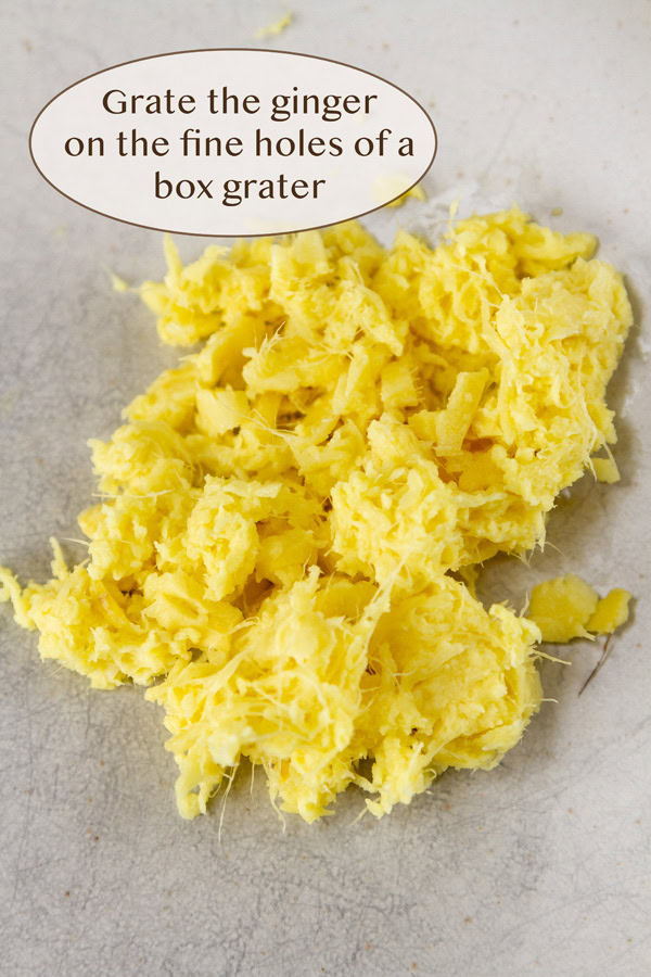 grated ginger in a pile on a white plate.