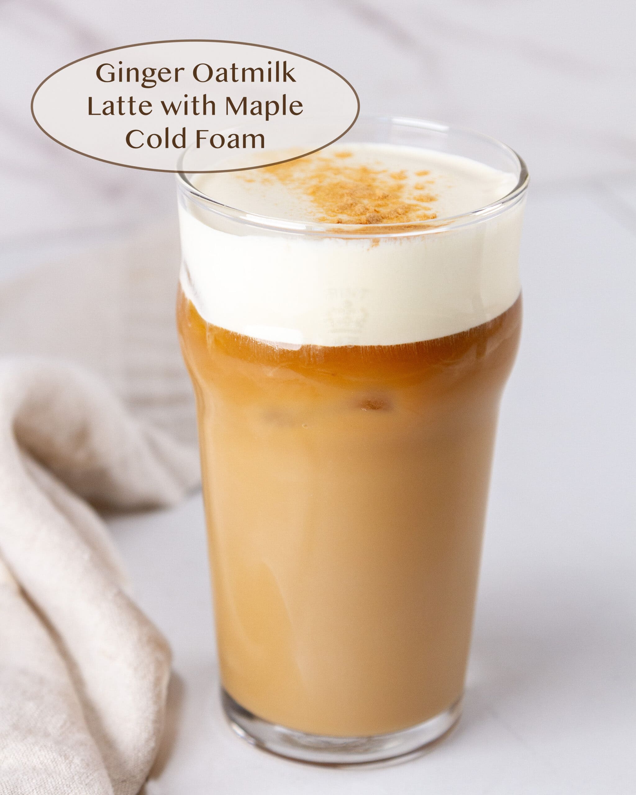 Ginger Oatmilk Latte with Maple Cold Foam on a white background.