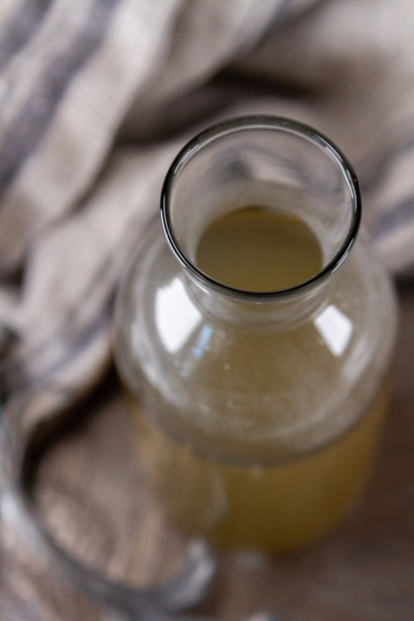 looking down into a bottle filled with syrup.