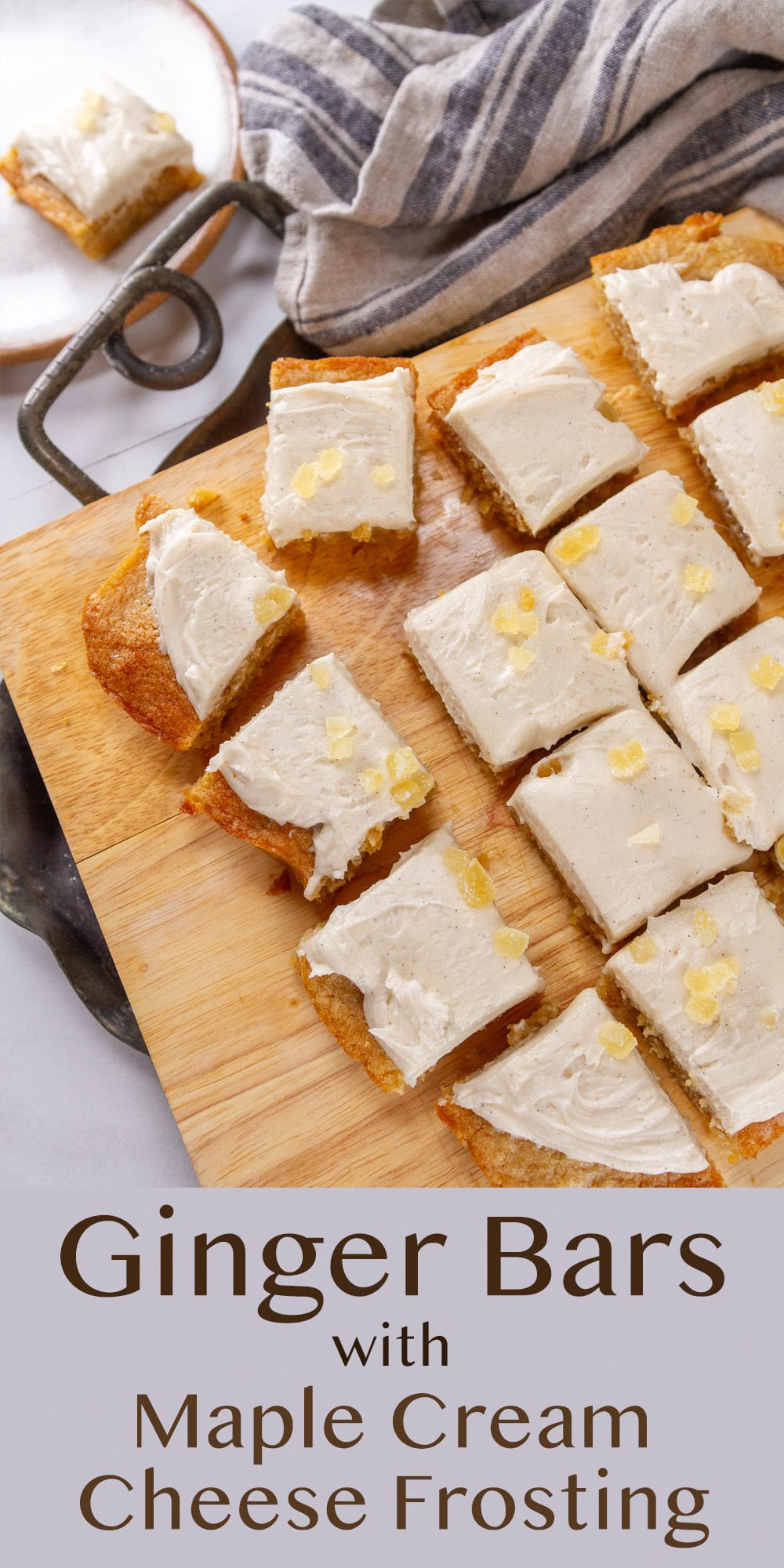 sliced dessert bars on a wooden cutting board with a towel next to it.