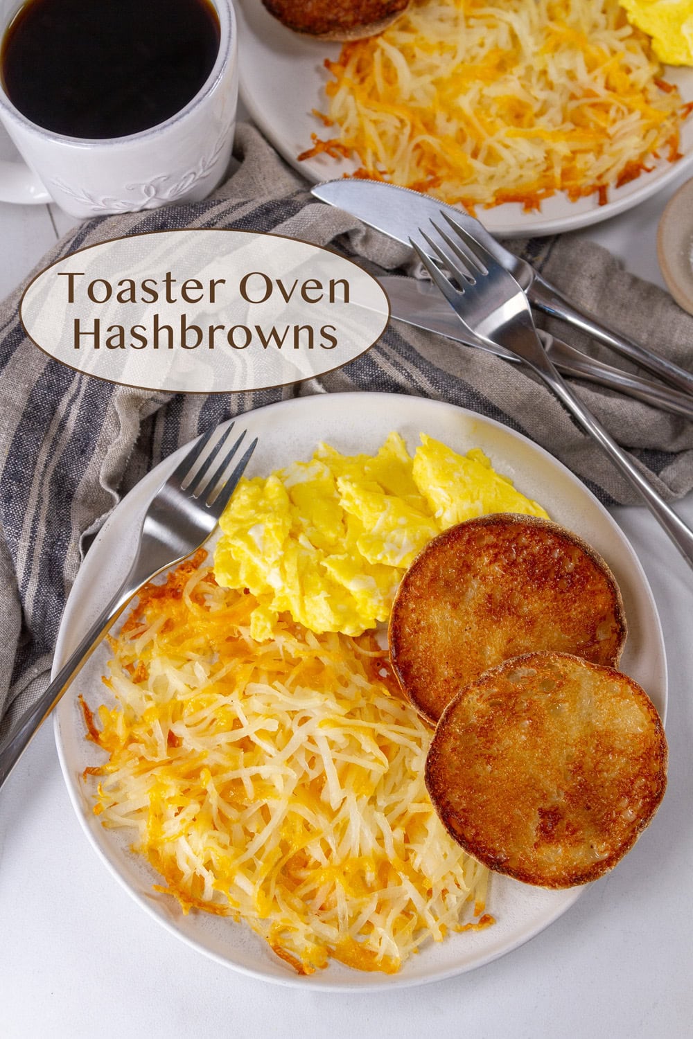 looking down on a plate with hashbrowns and eggs and a English muffin.