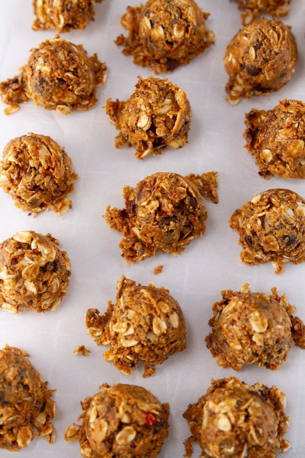Trail mix peanut butter balls on parchment paper.