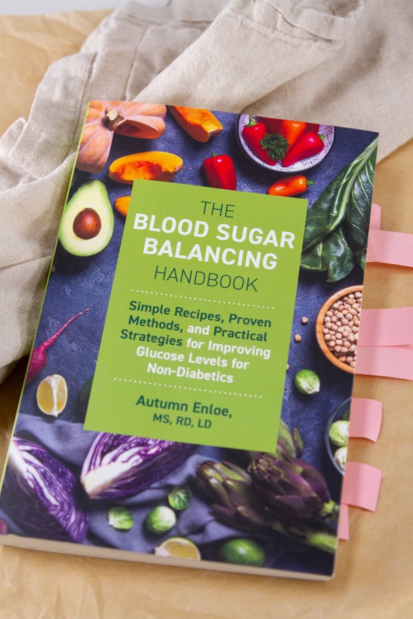 a copy of the book The Blood Sugar Balancing Handbook: Simple Recipes, Proven Methods, and Practical Strategies for Improving Glucose Levels for Non-Diabetics with flagged pages.