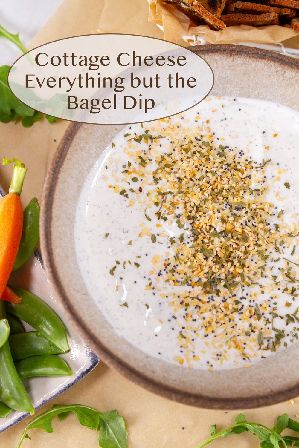 a bowl of Everything but the Bagel Dip with veggies around it.